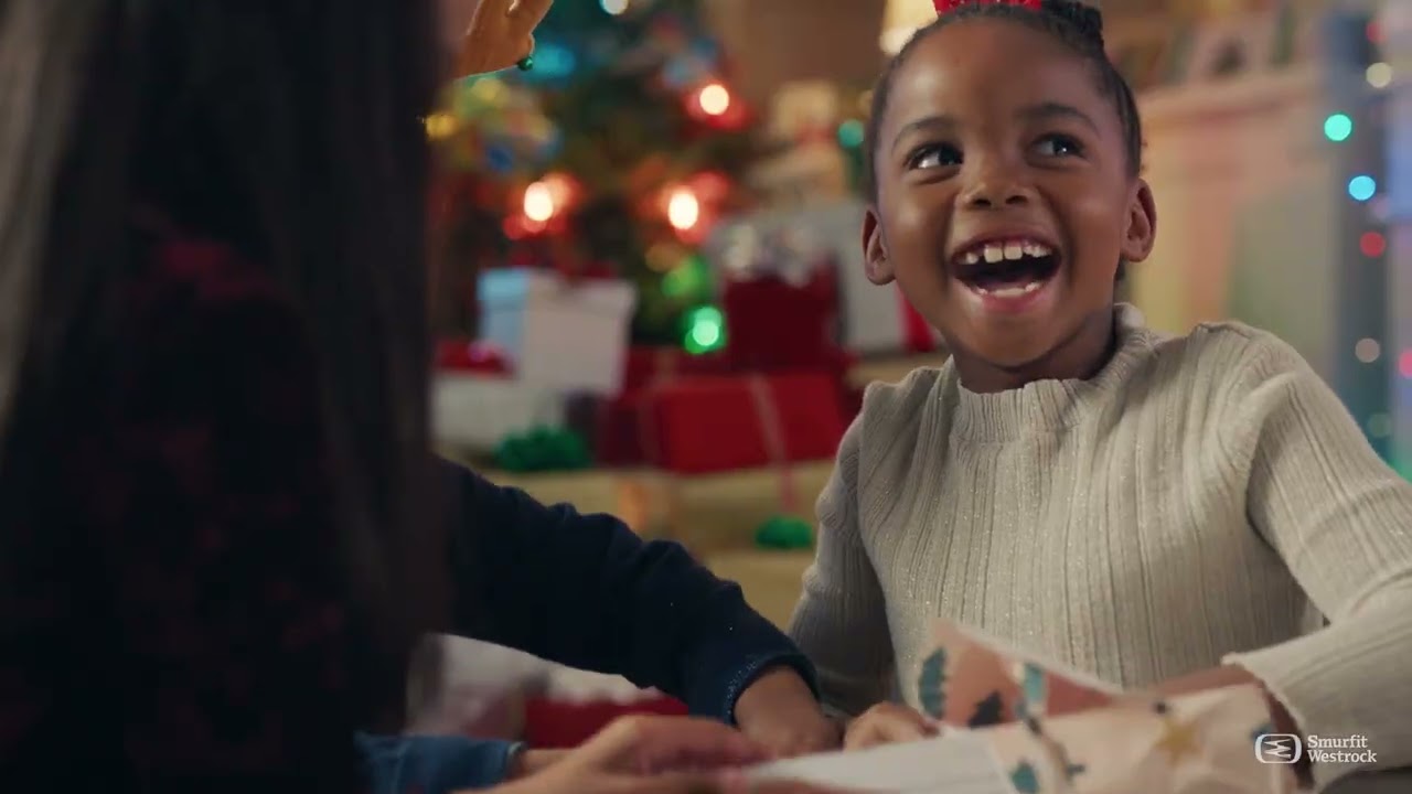 little girl opening a package